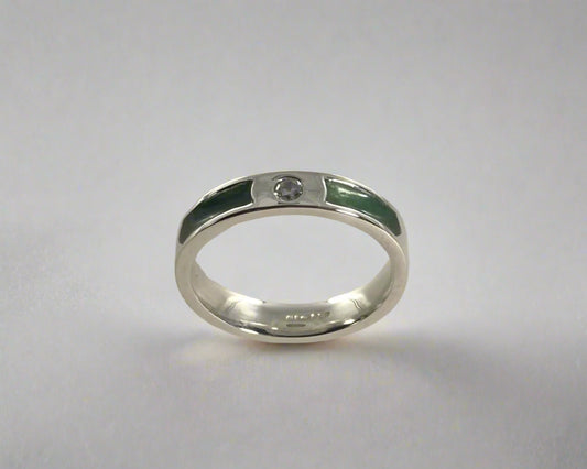 Single Brilliant cut stone set in rub over 4mm wide Flat-shaped Tribute ring with Diamond dust in resin