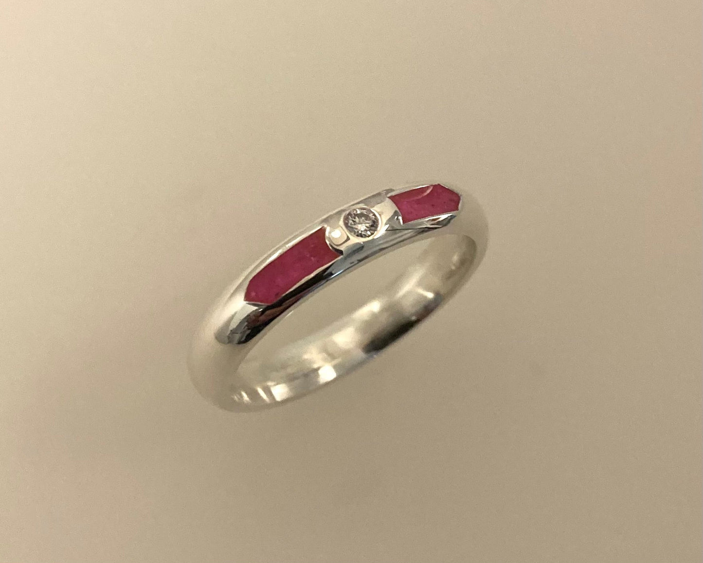 Single Brilliant cut stone set in rub over 4mm wide D-shaped Tribute ring with Diamond dust in resin