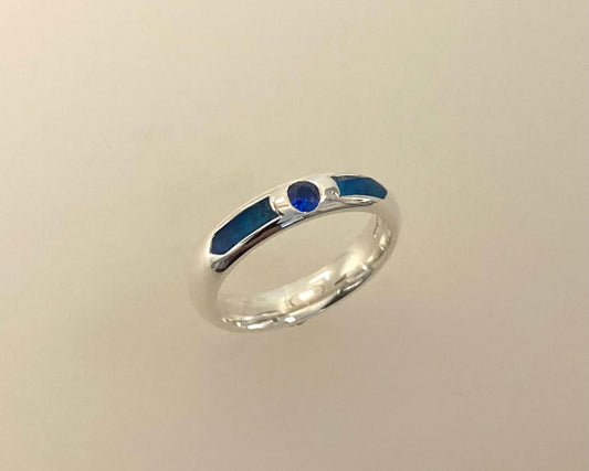 Single Brilliant cut stone set in rub over 4mm wide D-shaped ring with ashes in resin