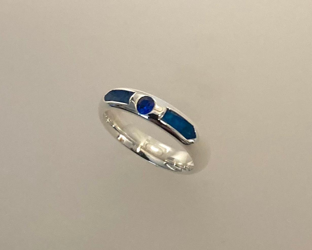 Single Brilliant cut stone set in rub over 4mm wide D-shaped Tribute ring with Diamond dust in resin