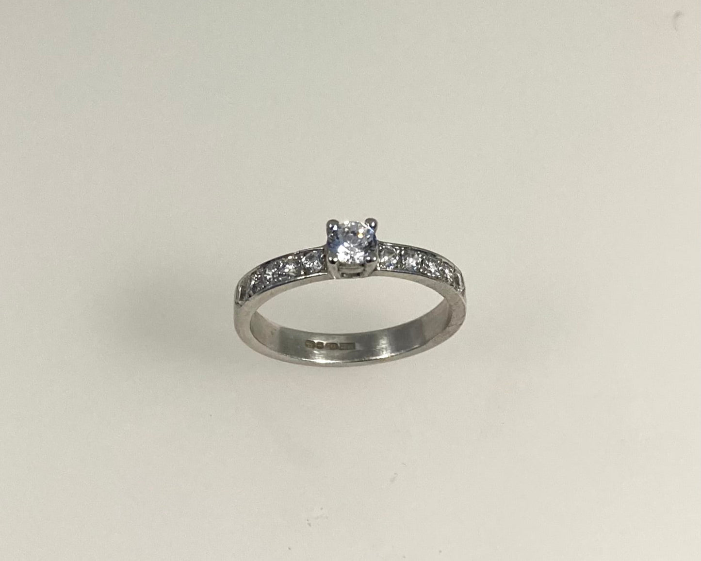 Claw plus pavé set 3mm wide ring with hidden ashes inside shank