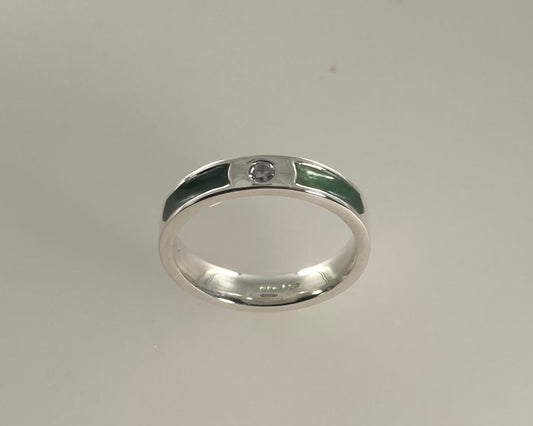 Single brilliant cut stone set in rub over 4mm wide Tribute ring with Diamond dust in resin