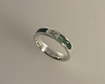 Single brilliant cut stone set in rub over 4mm wide ring with ashes in resin