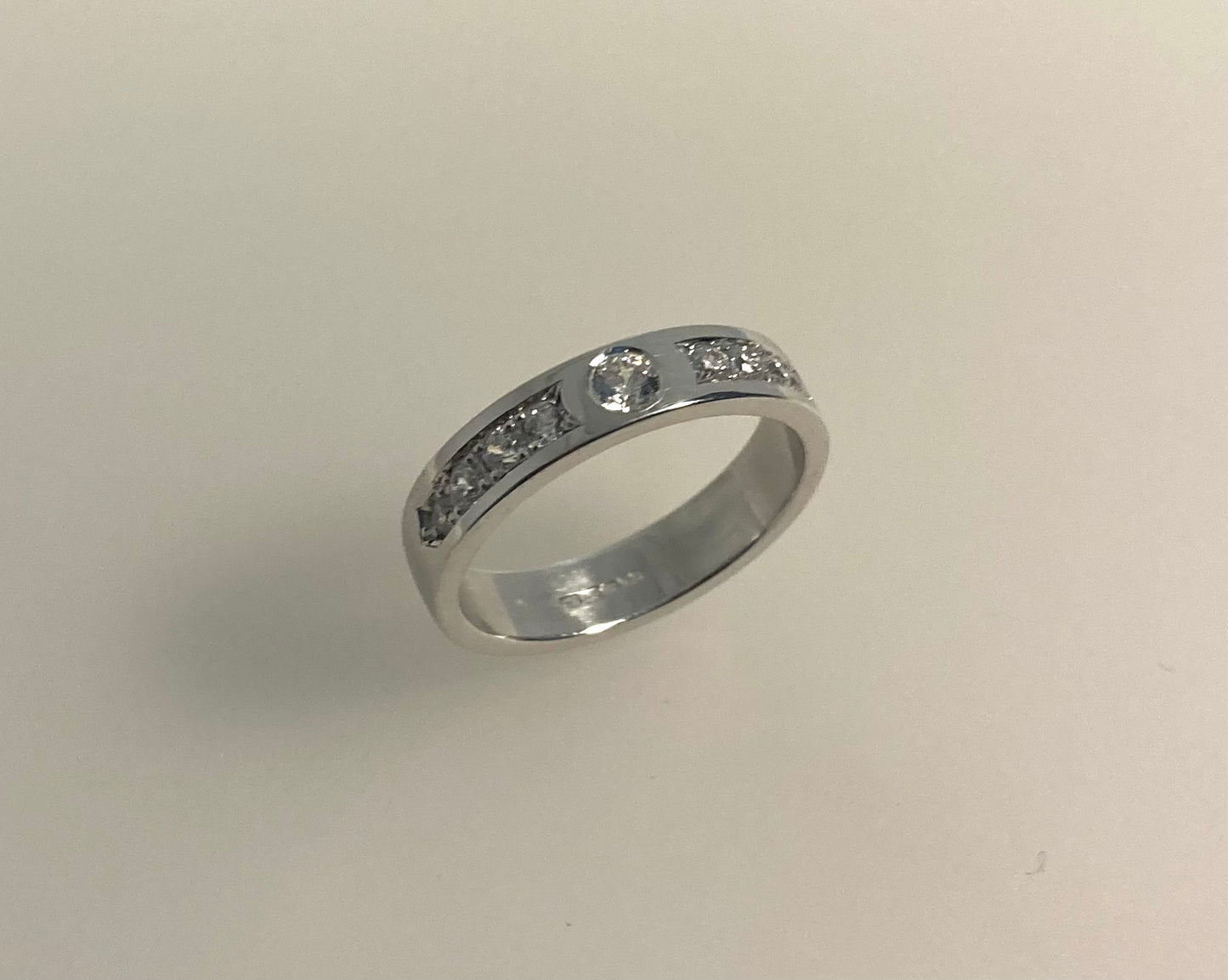 Rub over and pavé set 4mm wide ring with hidden ashes inside shank