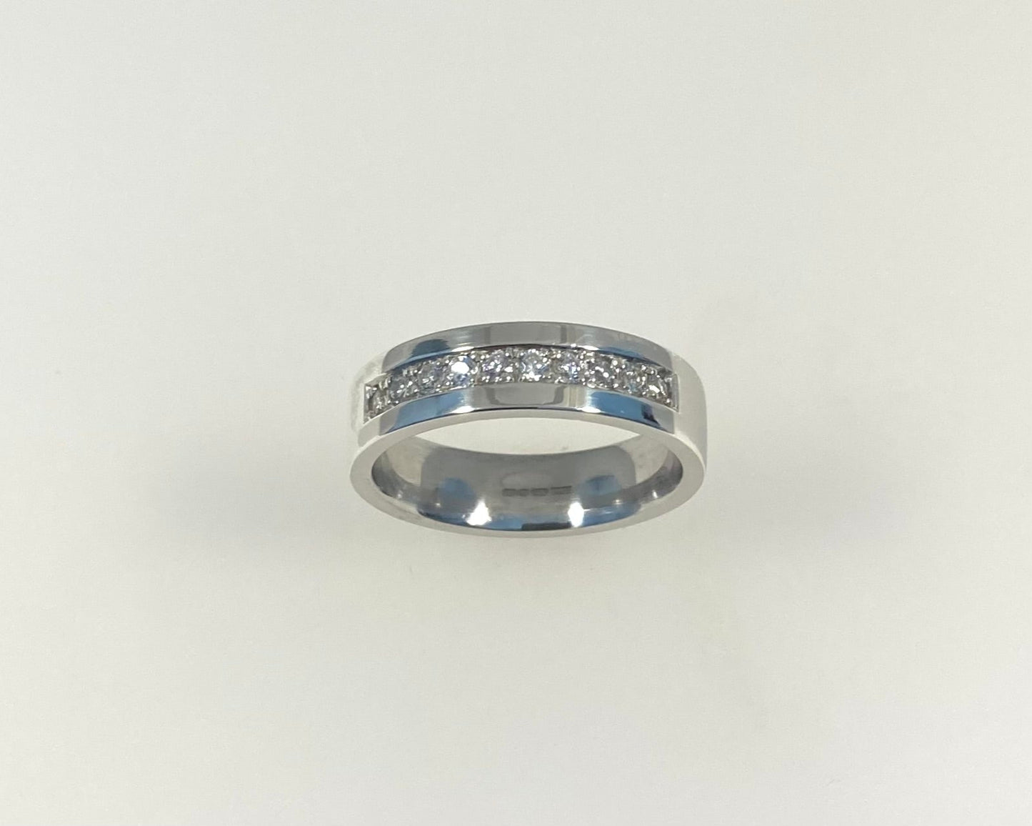 Pavé set 5mm wide flat ring with hidden ashes inside shank
