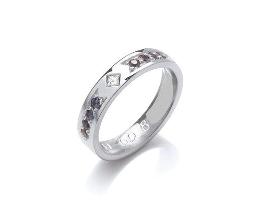 Princess cut diamond set on edge with blue sapphires 4mm wide flat profile ring with hidden ashes inside shank